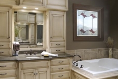 Elegant bathroom vanity with frosted window above tub