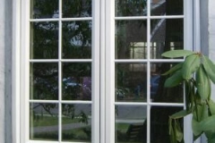 Exterior double casement windows showing living room interior