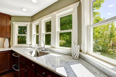 Kitchen sink surrounded by bay windows